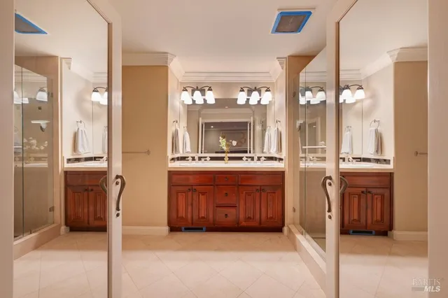 a large bathroom with mirror and a sink