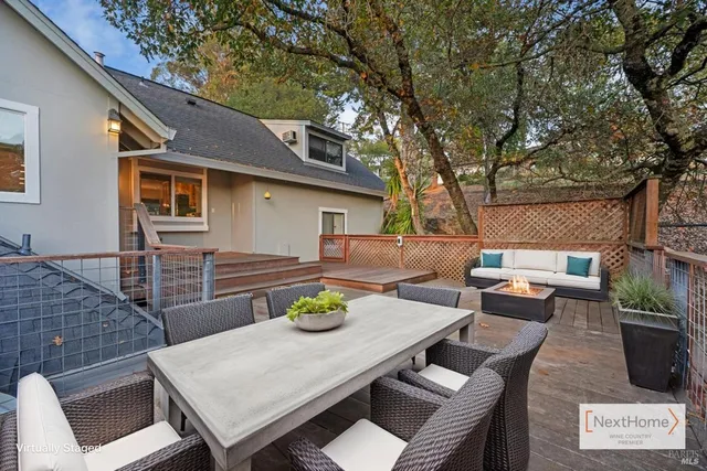 a view of a patio with couches table and chairs and potted plants