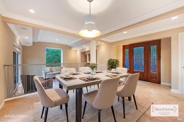 a dining room with furniture a chandelier and window