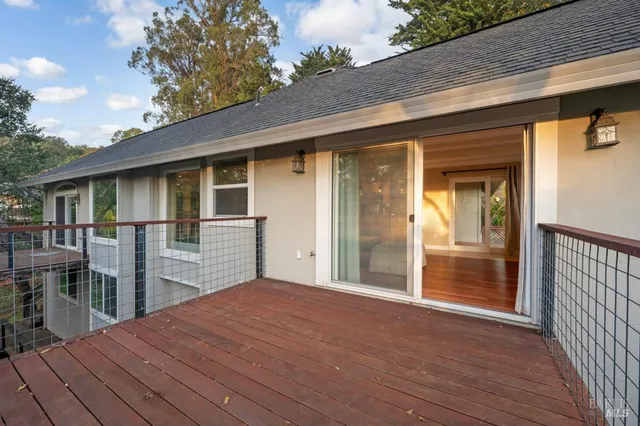 a view of a house with wooden floor and wooden fence