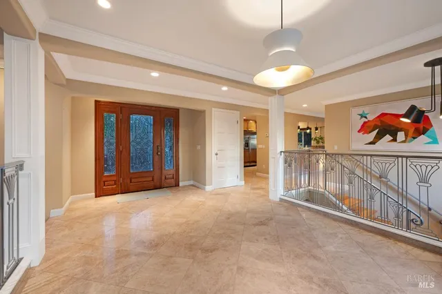 a view of a hallway with wooden floor and windows