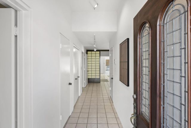 a spacious bedroom with a large bed and a chandelier