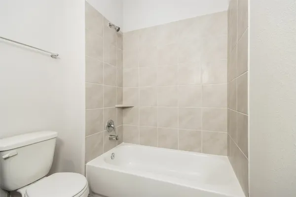 a white bath tub sitting next to a white toilet