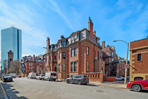 a living room with furniture a window and a mirror