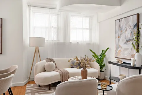 a living room with furniture and a potted plant