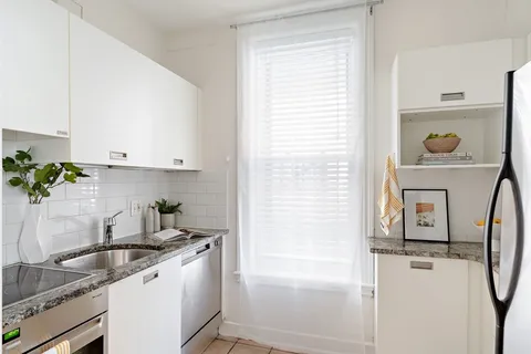 a kitchen with a sink and cabinets