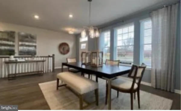 a view of a a dining room with furniture window and wooden floor