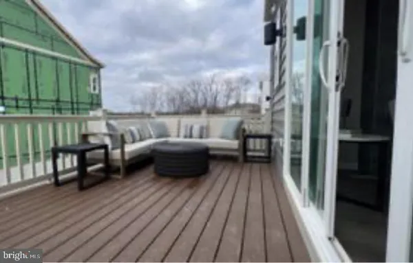 a view of a balcony with couch and wooden floor