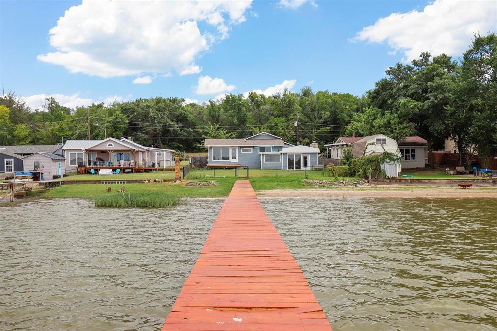 View of dock featuring a water view and a yard