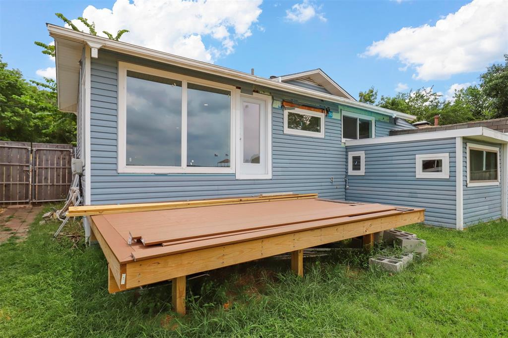 8048 Woodvale Road Fort Worth, TX 76135 - Photo 11 of 27 Rear view of house with a yard