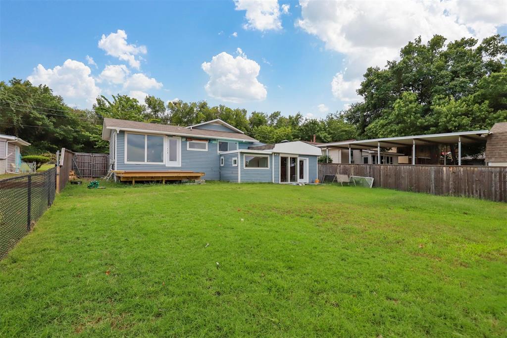 8048 Woodvale Road Fort Worth, TX 76135 - Photo 12 of 27 Back of property with a yard