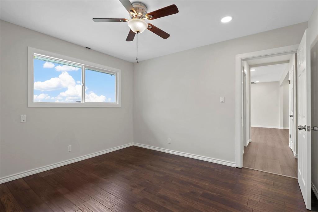 8048 Woodvale Road Fort Worth, TX 76135 - Photo 23 of 27 Spare room featuring ceiling fan and hardwood / wood-style floors