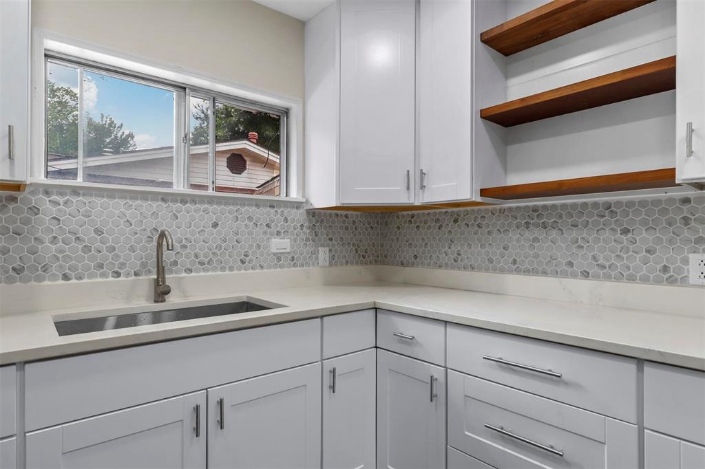 8048 Woodvale Road Fort Worth, TX 76135 - Photo 26 of 27 Kitchen with white cabinets, tasteful backsplash, and sink