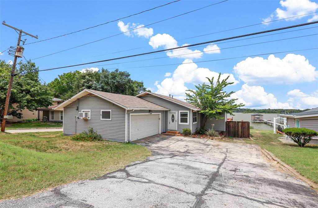 8048 Woodvale Road Fort Worth, TX 76135 - Photo 5 of 27 View of front facade with a garage and a front lawn