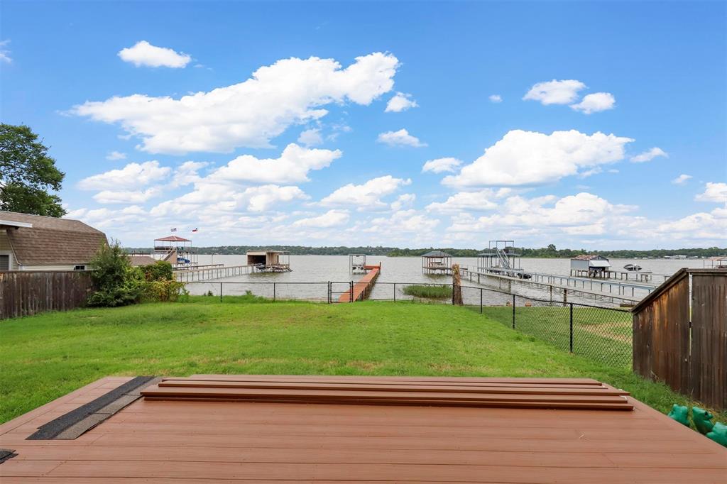 8048 Woodvale Road Fort Worth, TX 76135 - Photo 10 of 27 Wooden deck featuring a boat dock and a yard