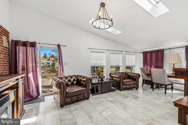 a living room with furniture a couch and a flat screen tv