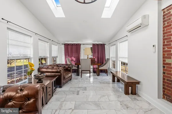 a living room with furniture a window and a table