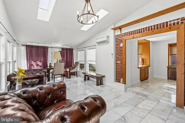 a living room with furniture and a chandelier