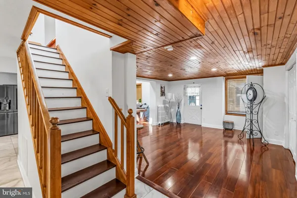 a view of entryway and hall with wooden floor