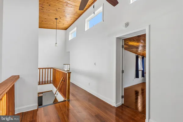 a view of hallway with wooden floor