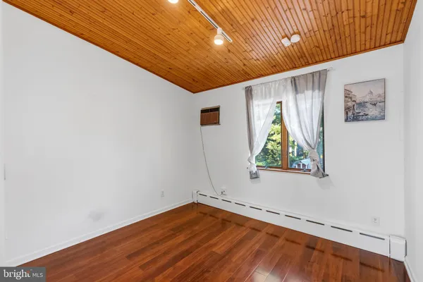 a view of empty room with wooden floor