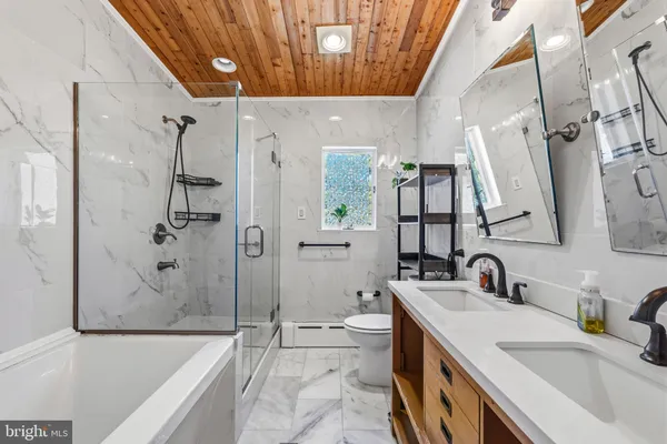 a spacious bathroom with a tub sink and mirror