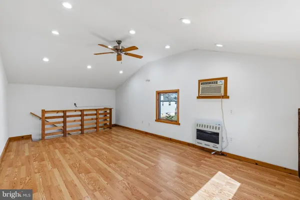 a view of a room with furniture and a ceiling fan