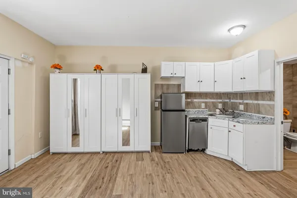 a kitchen with a refrigerator and a stove top oven