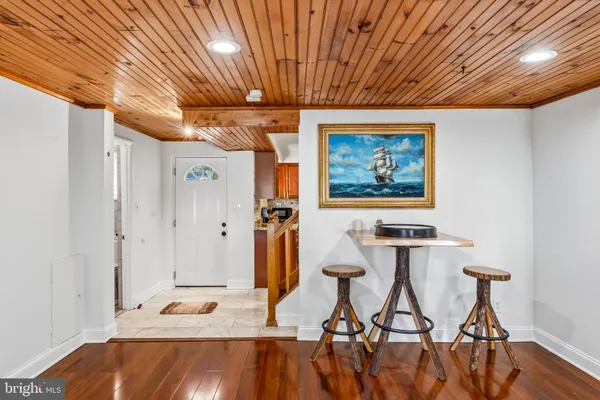 a view of a room with furniture and wooden floor
