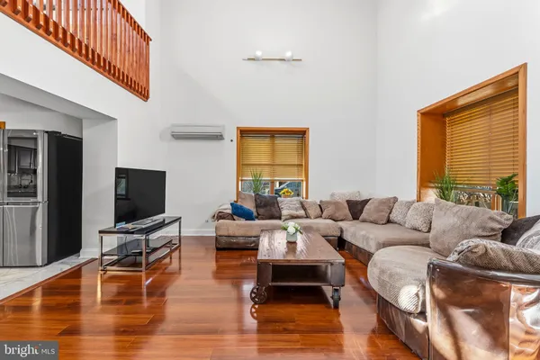 a living room with furniture wooden floor and a flat screen tv