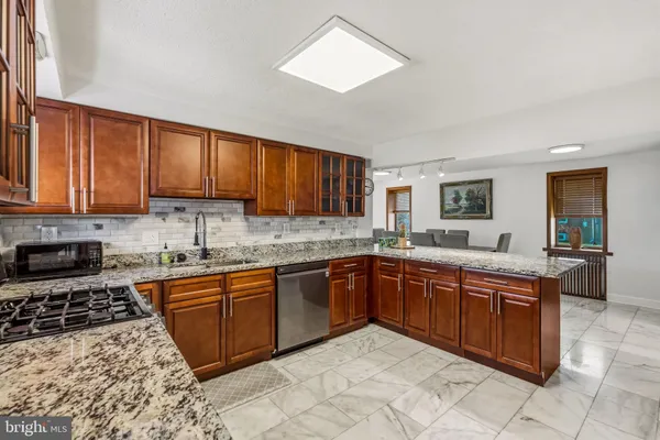 a kitchen with stainless steel appliances granite countertop a sink and cabinets
