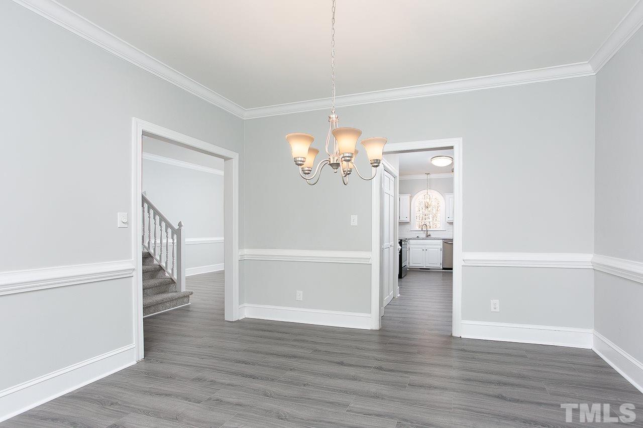 6830 Gloucester Road Raleigh, NC 27612 - Photo 13 of 28 a view of a hallway view with wooden floor and a cabinet
