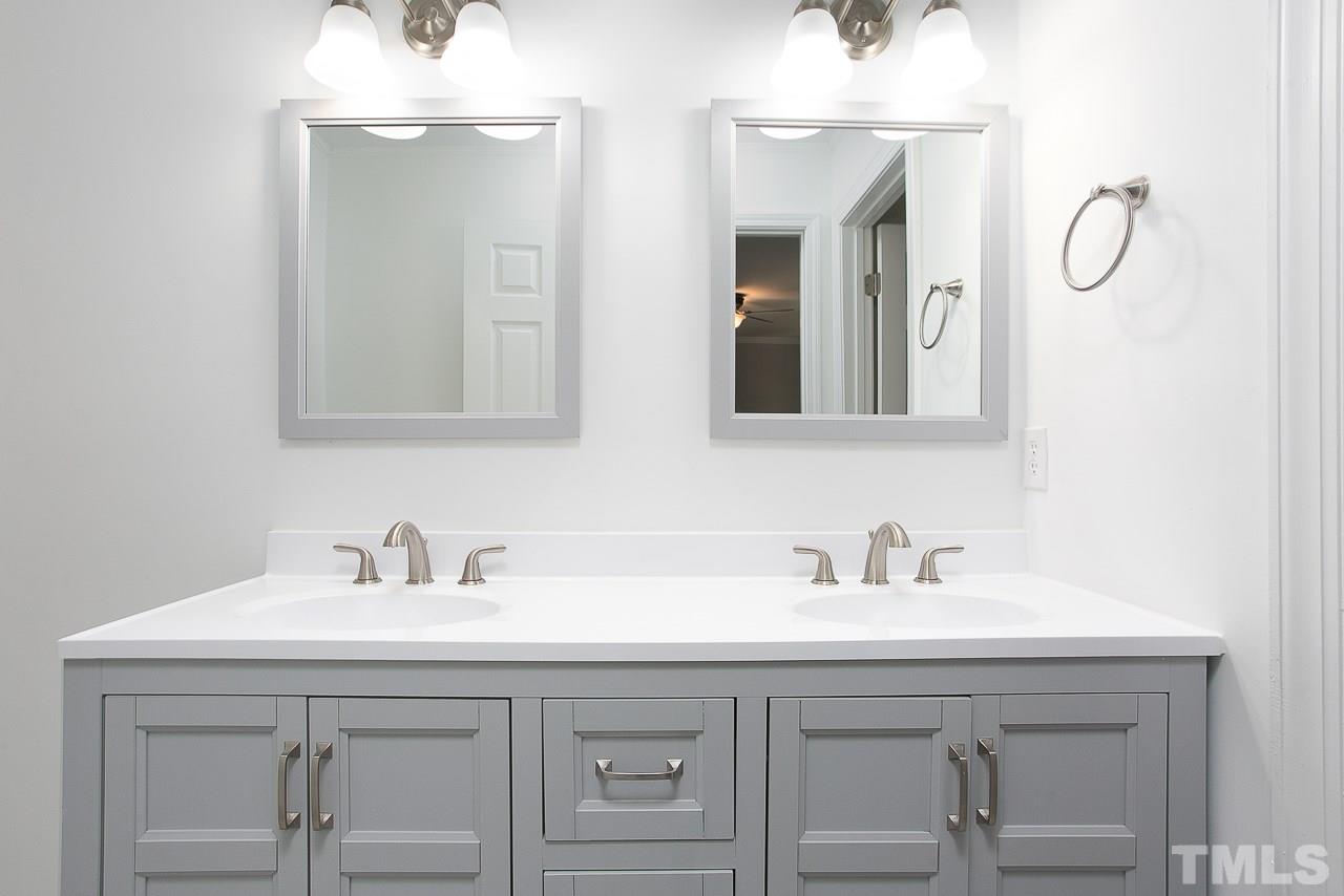 6830 Gloucester Road Raleigh, NC 27612 - Photo 14 of 28 a bathroom with a sink and a mirror