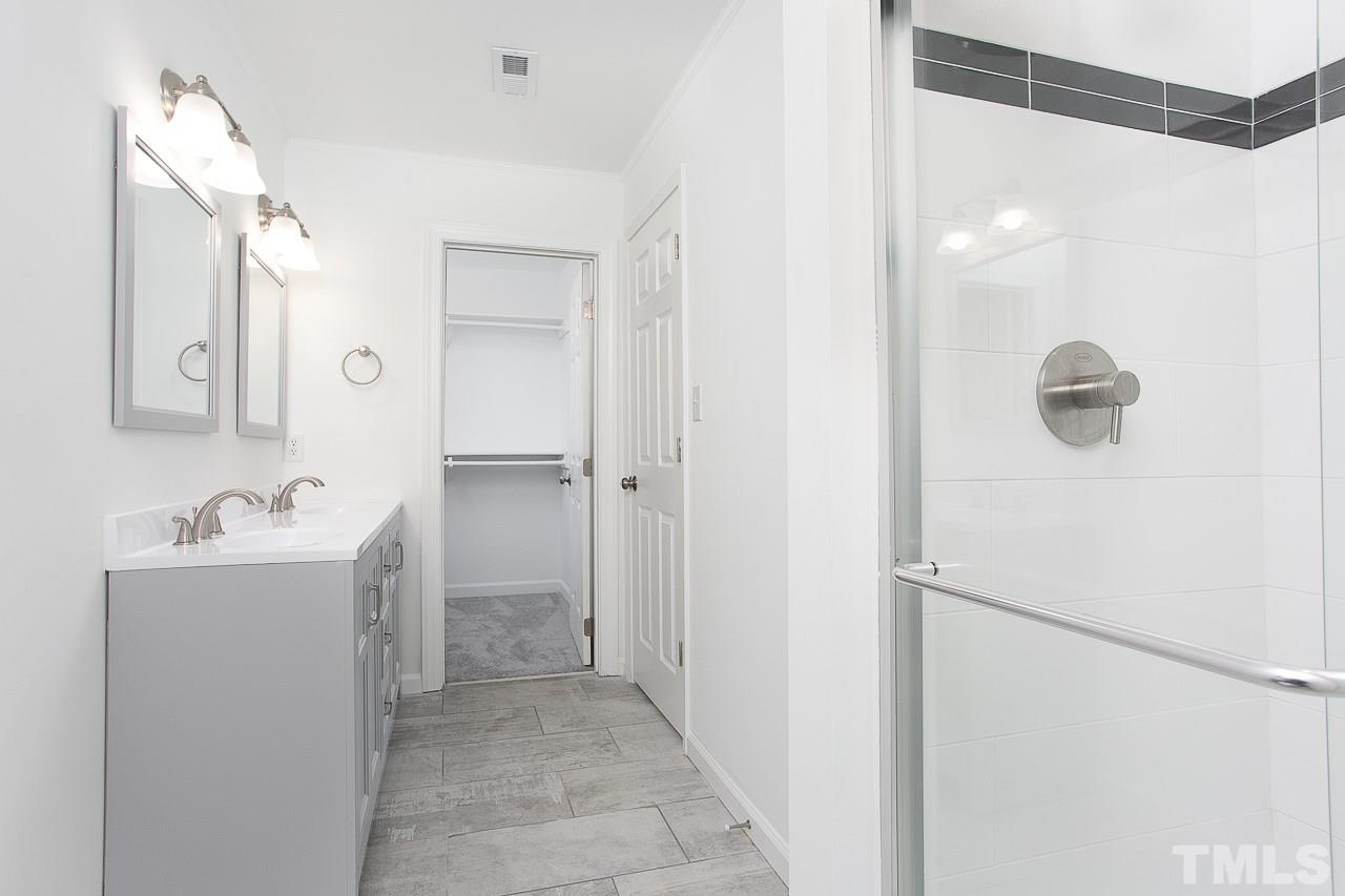 6830 Gloucester Road Raleigh, NC 27612 - Photo 15 of 28 a view of a hallway with closet and wooden floor