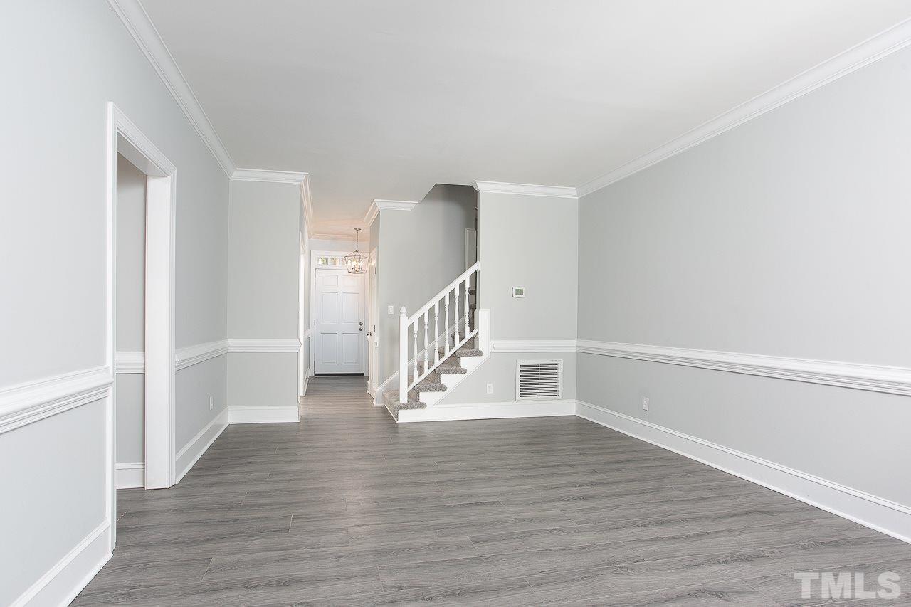 6830 Gloucester Road Raleigh, NC 27612 - Photo 9 of 28 a view of entryway with wooden floor
