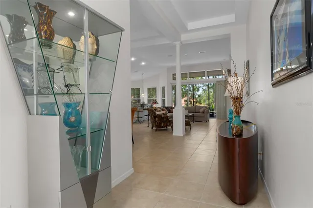 a living room with furniture and large windows