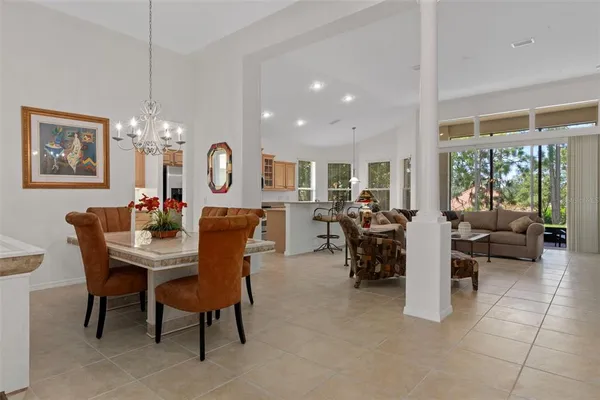 a living room with furniture and a view of kitchen