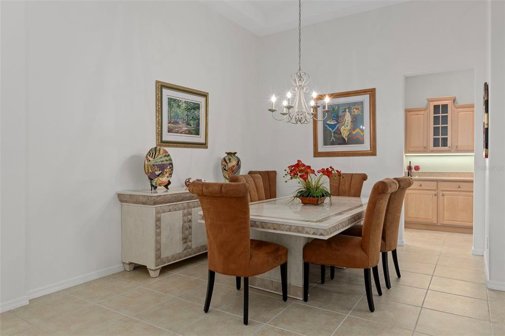 1031 West Diamond Shore Loop, Unit 5 Hernando, FL 34442 - Photo 15 of 69 a view of a dining room with furniture and chandelier