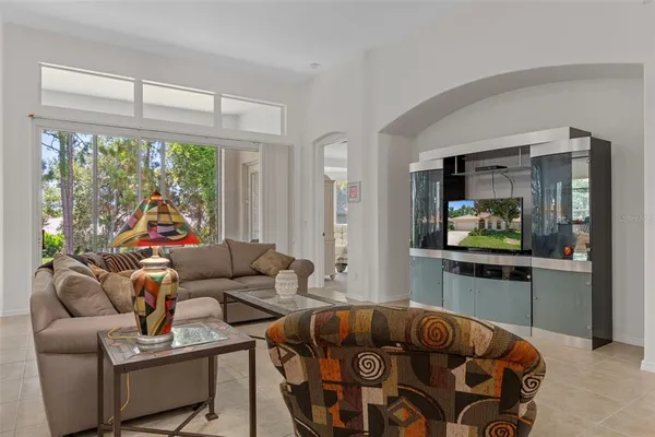 a kitchen with stainless steel appliances granite countertop a stove top oven a sink dishwasher a dining table and chairs with wooden floor