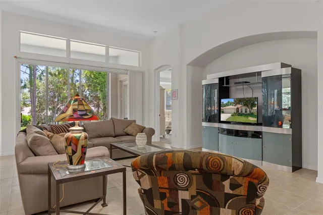 a kitchen with stainless steel appliances granite countertop a stove top oven a sink dishwasher a dining table and chairs with wooden floor