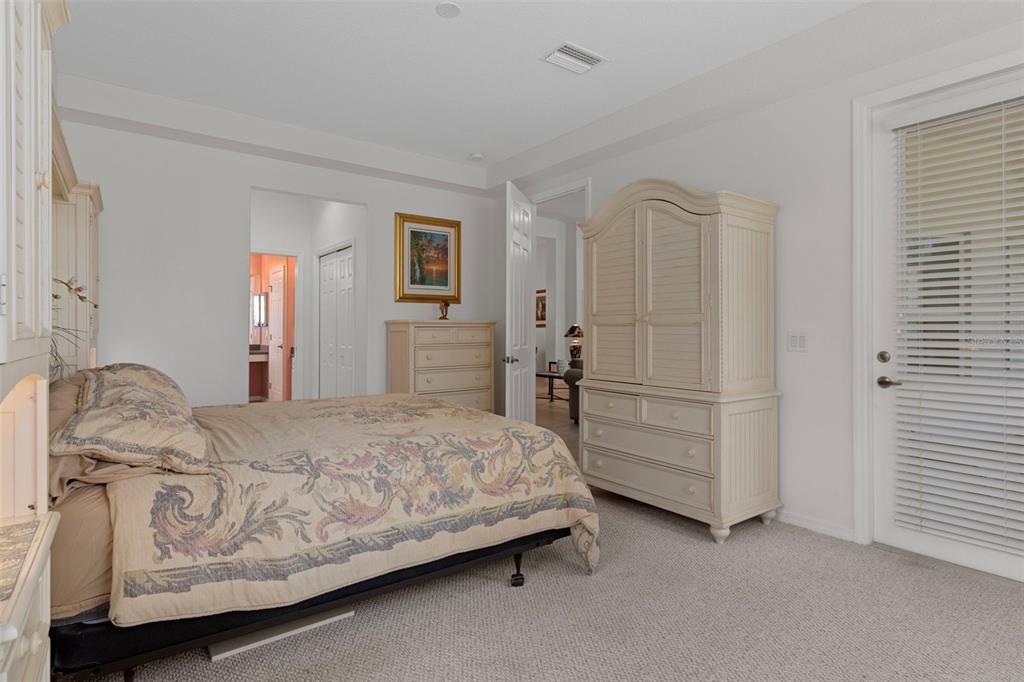 1031 West Diamond Shore Loop, Unit 5 Hernando, FL 34442 - Photo 28 of 69 a bedroom with a bed and a cabinets