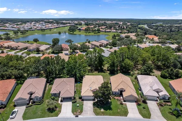 an aerial view of a residential houses with outdoor space and lake view