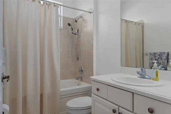 an aerial view of a house with a yard and trees all around