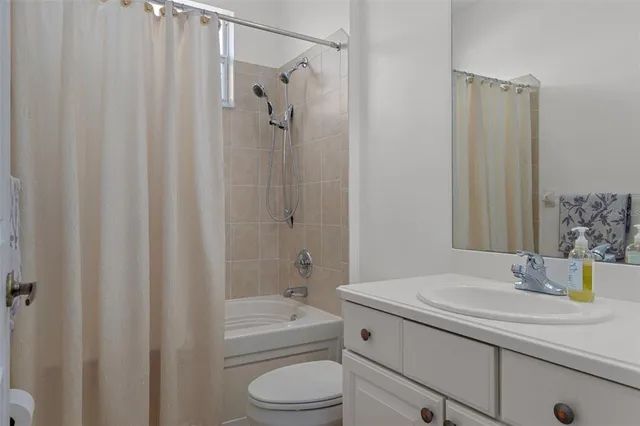 an aerial view of a house with a yard and trees all around