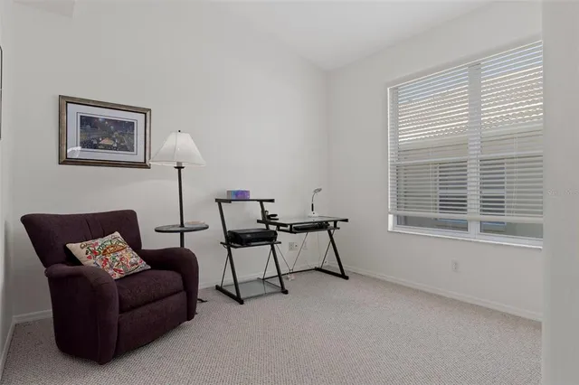 an aerial view of residential house with outdoor space and trees all around