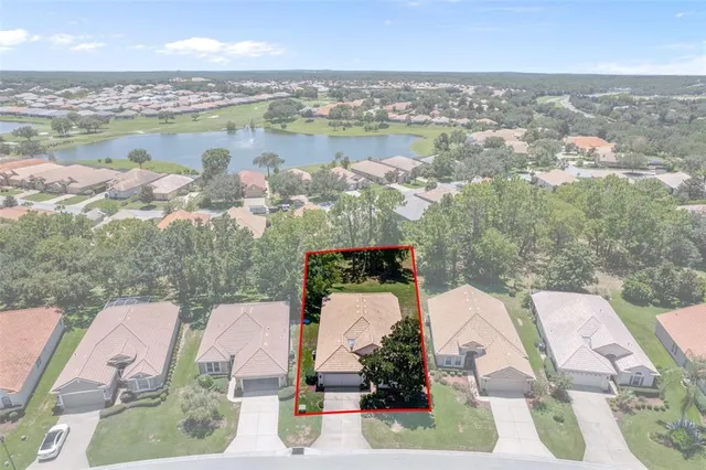 an aerial view of a city with lots of residential buildings ocean and mountain view in back