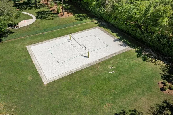 an aerial view of residential house with outdoor space and lake view in back