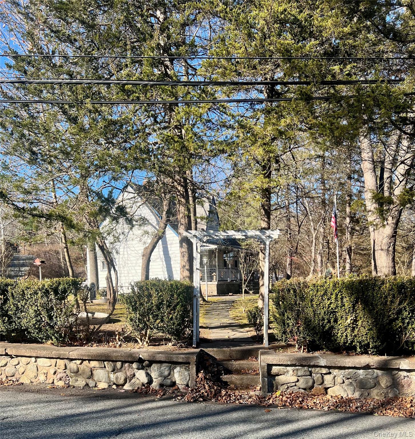 View of property surrounded by natural elements with a pergola