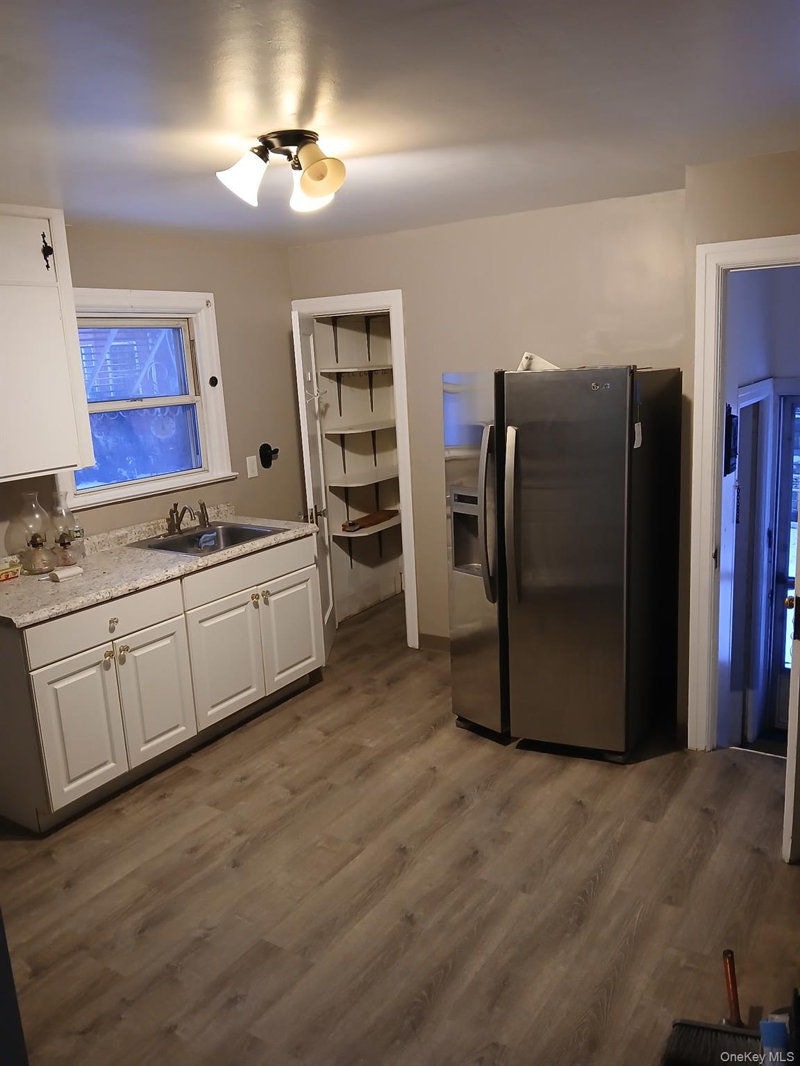 6 A Post Road Sloatsburg, NY 10974 - Photo 6 of 13 Kitchen featuring stainless steel fridge, light countertops, white cabinetry, and dark wood-type flooring