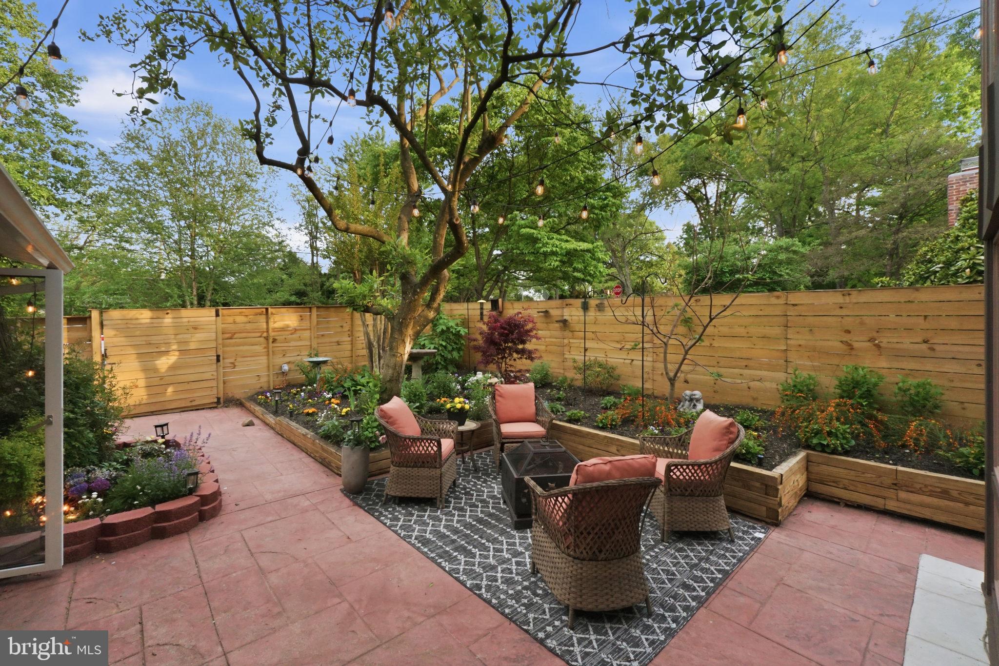 3311 Pendleton Drive Silver Spring, MD 20902 - Photo 4 of 45 a view of a patio with couches and a table and chairs with wooden floor and fence